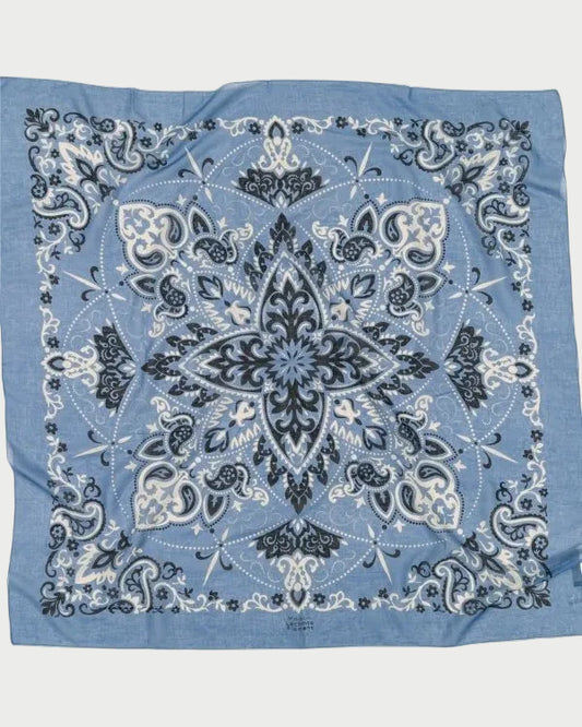 Blue bandana with black and white paisley pattern on a white background