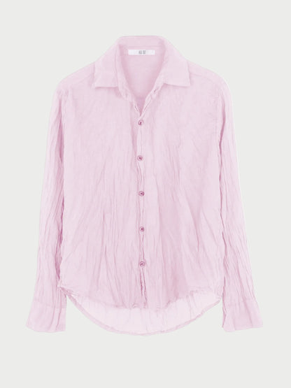 The All III Daniel Button Down by All III is an oversized, light pink cotton gauze shirt featuring long sleeves, a wrinkled texture, pointed collar, and curved hem. Displayed against a plain white background, this button-down offers effortless style and comfort.
