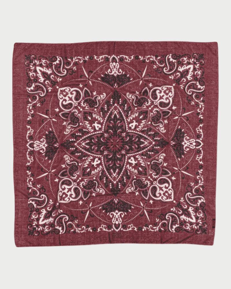 Red bandana with intricate black patterns on a white background