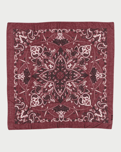 Red bandana with intricate black patterns on a white background