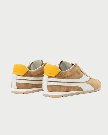The Oncept Essex Sneaker - Ginger is a brown suede sneaker with white accents and yellow heel tabs, shown on a white background at an angle to highlight the back and side. These eco-conscious sneakers blend style and comfort from Oncept.