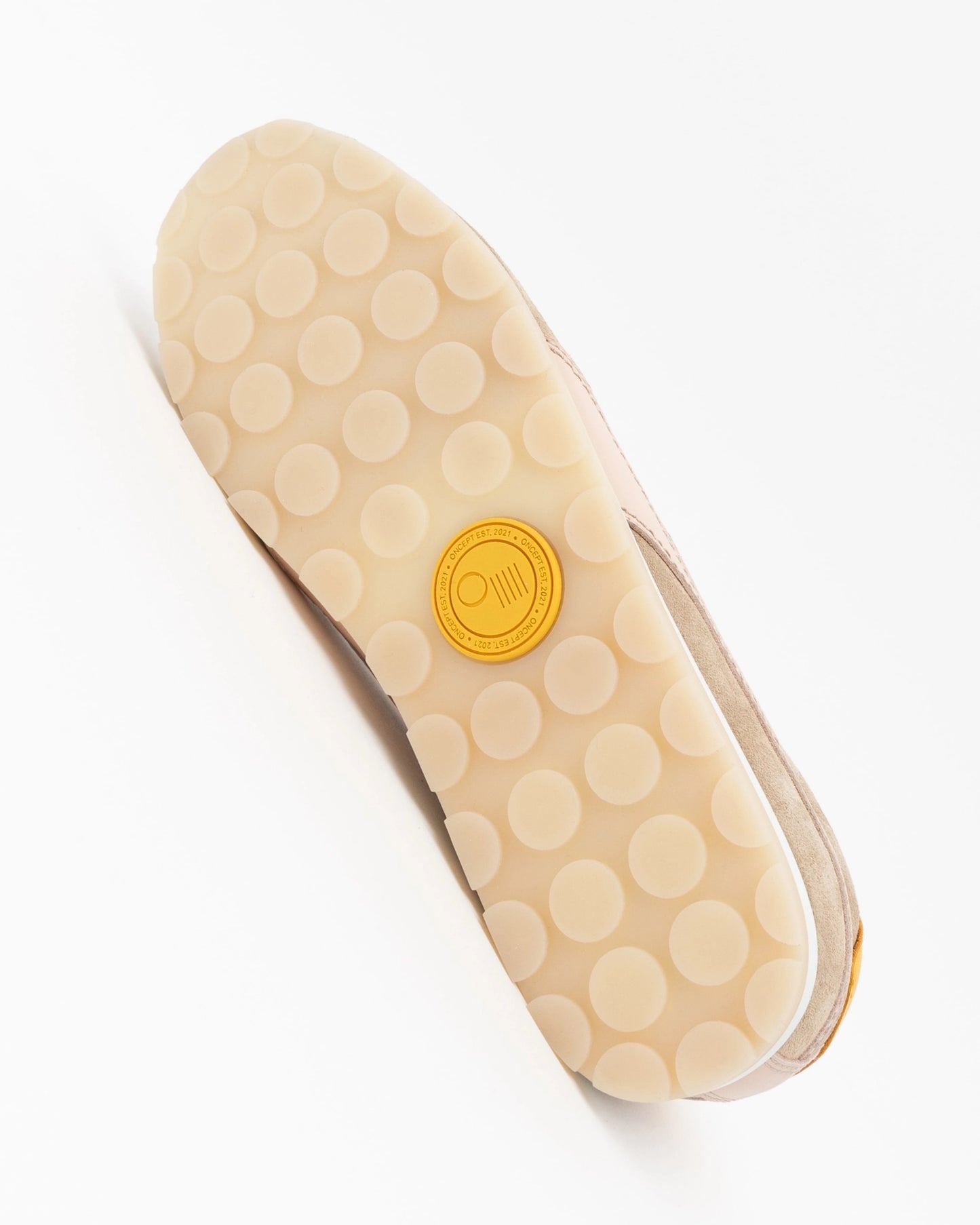 Beige shoe sole with a yellow logo on a white background