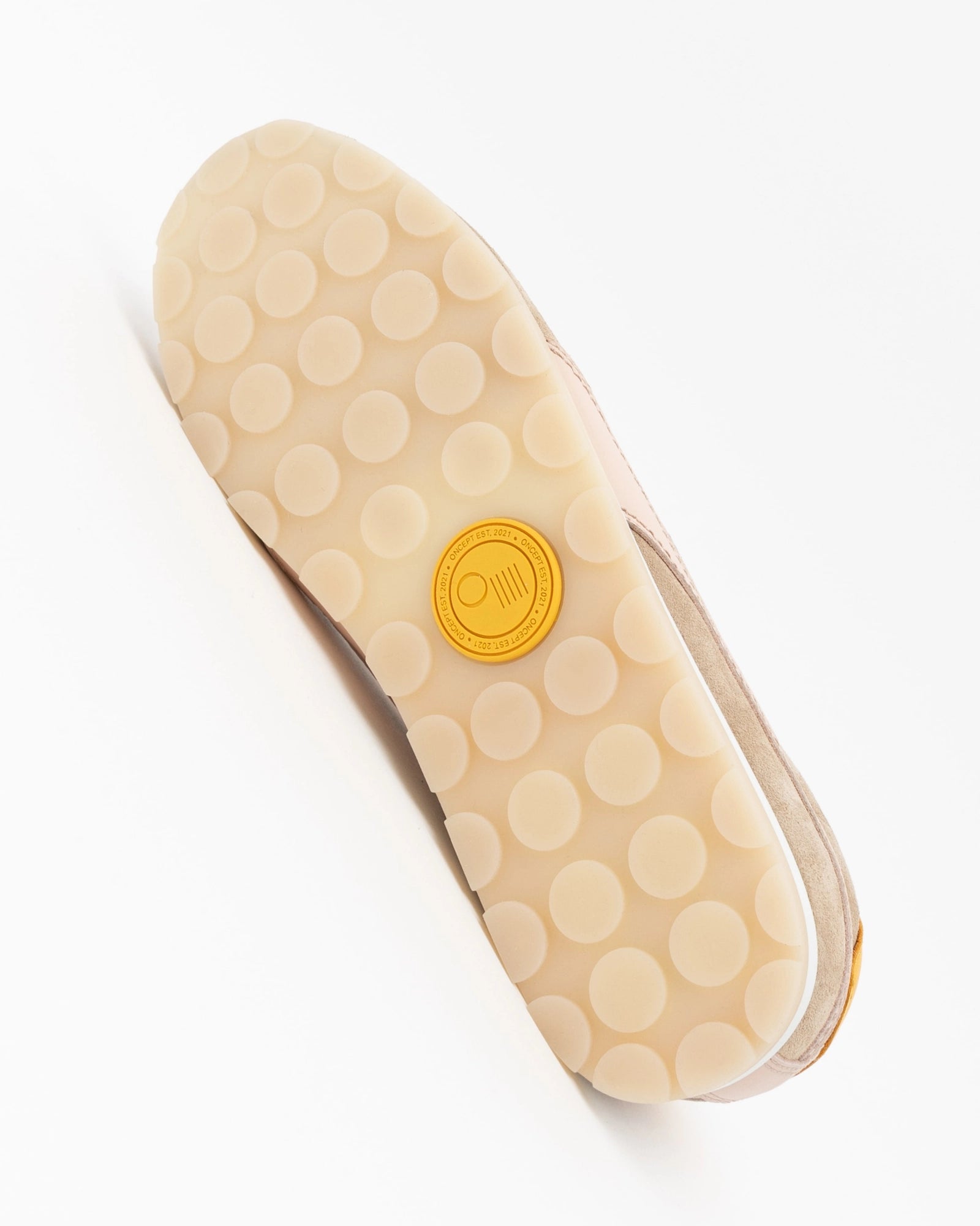 Beige shoe sole with a yellow logo on a white background