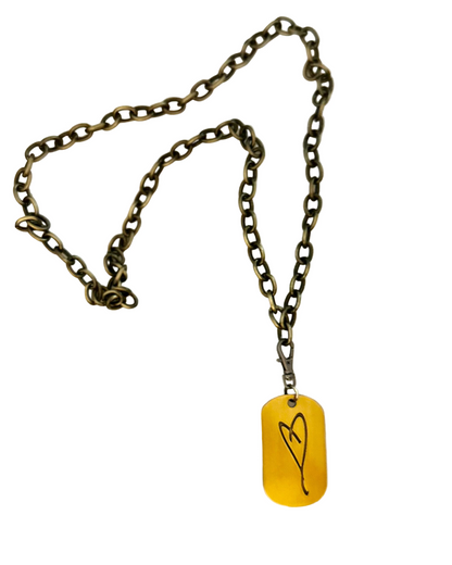 The Simply Eartha "Here's To Life/EK Heart" bronze chain necklace features a yellow dog tag pendant with a simple black heart line drawing, photographed on a white background.