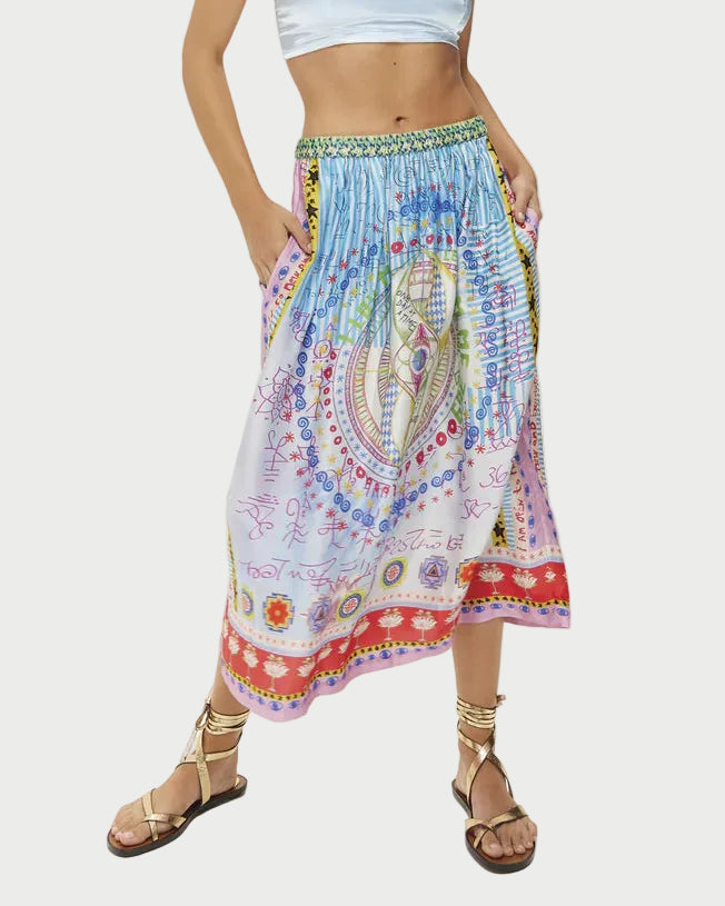 Colorful patterned skirt worn by a person on a white background