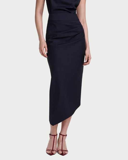 Woman wearing a black sleeveless dress with a draped neckline on a white background