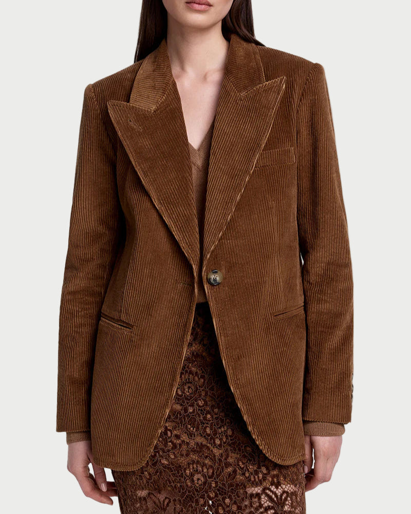 Woman wearing a brown corduroy blazer on a white background