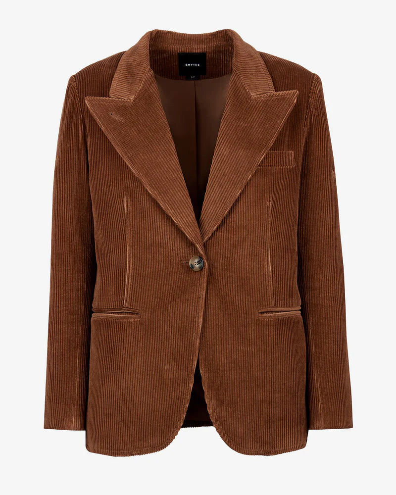The Smythe 90's Blazer is a brown corduroy jacket with a relaxed fit, notched lapel, single button closure, and three front pockets, shown against a white background.