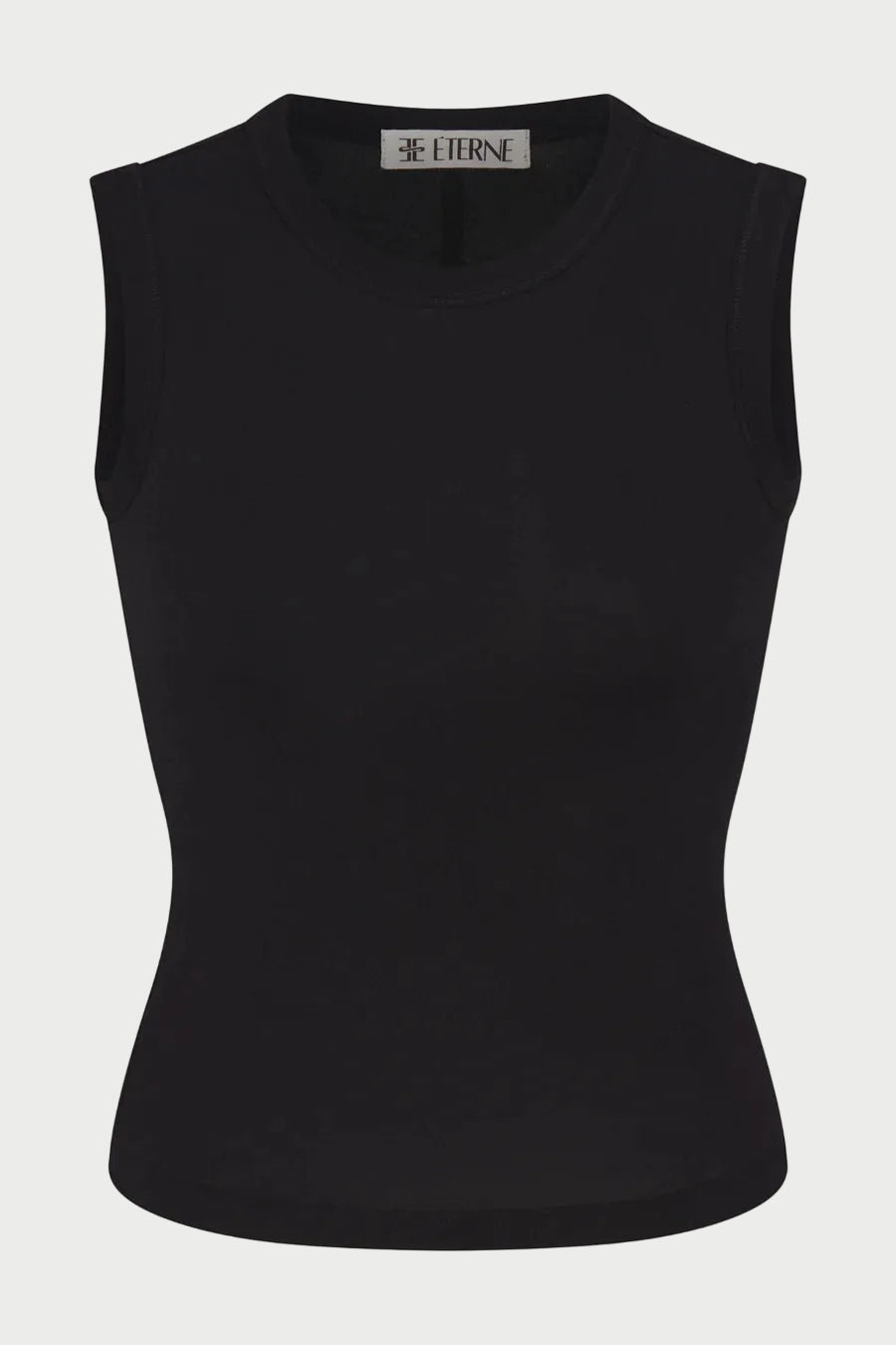 The Éterne Fitted Muscle Tank by Eterne is a sleeveless, fitted black top featuring a crew neckline. Made from a smooth and stretchy cotton-modal blend, this muscle tank offers a snug, comfortable fit and includes the brand’s signature “ETERNE” label inside the collar.