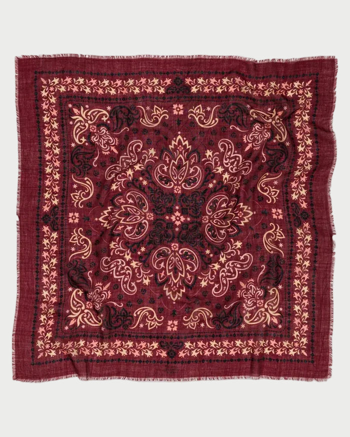 Maison Lecomte Flament Bandana Scarf Salem in square burgundy with a black and cream paisley and floral pattern and a raw, frayed edge.