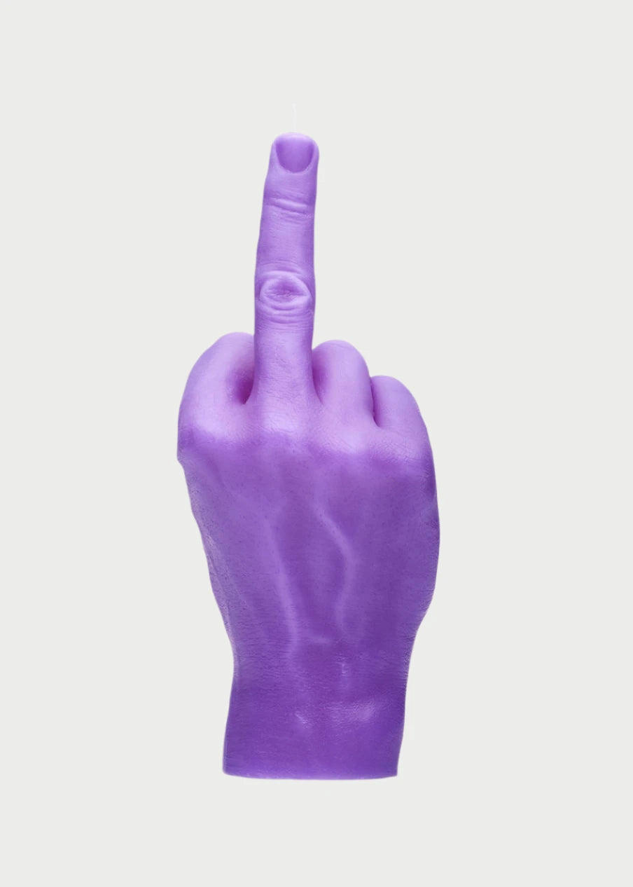 A purple F*ck You Candle Hand by 54° Celsius, moodily shaped like a human hand giving the middle finger gesture, stands defiantly against a plain white background.