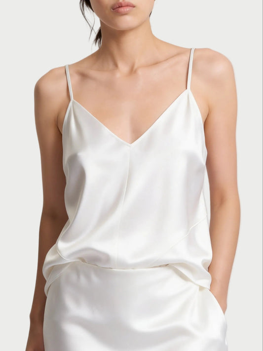 A person wearing a white Saint Art Finn Cami with thin shoulder straps, a V-neckline, and a relaxed silhouette.