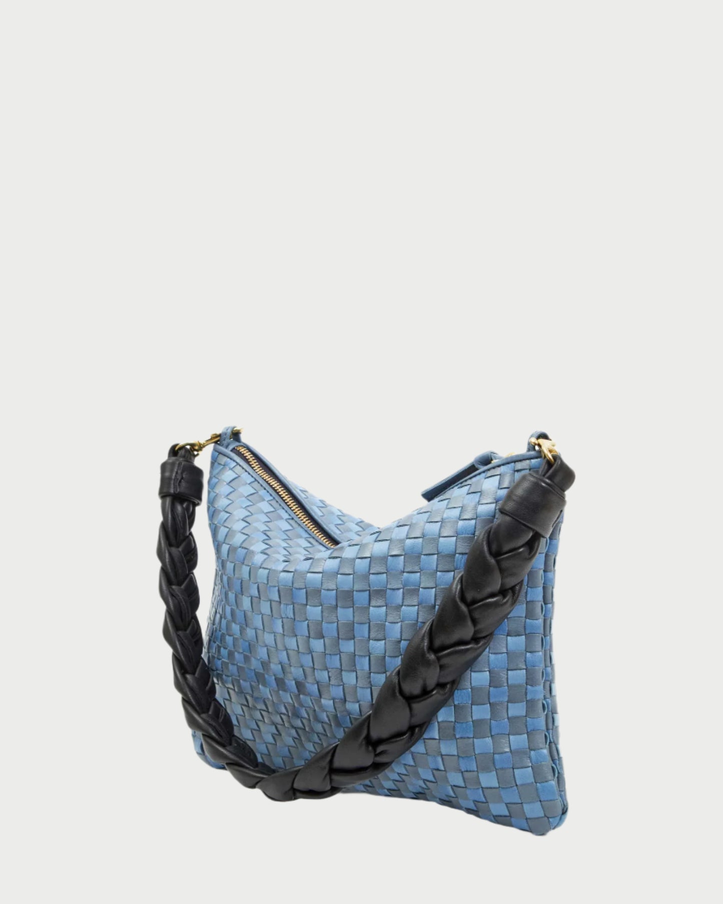 The Flat Clutch w/ Tabs by CLARE V. is a versatile handbag with a blue woven texture and a thick black braided strap. Made from handwoven leather, it features a zippered top and sleek design, presented on a plain white background.