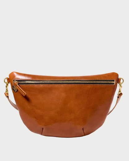A warm brown leather crescent-shaped belt bag with a top zipper and gold-tone hardware, shown against a plain white background.