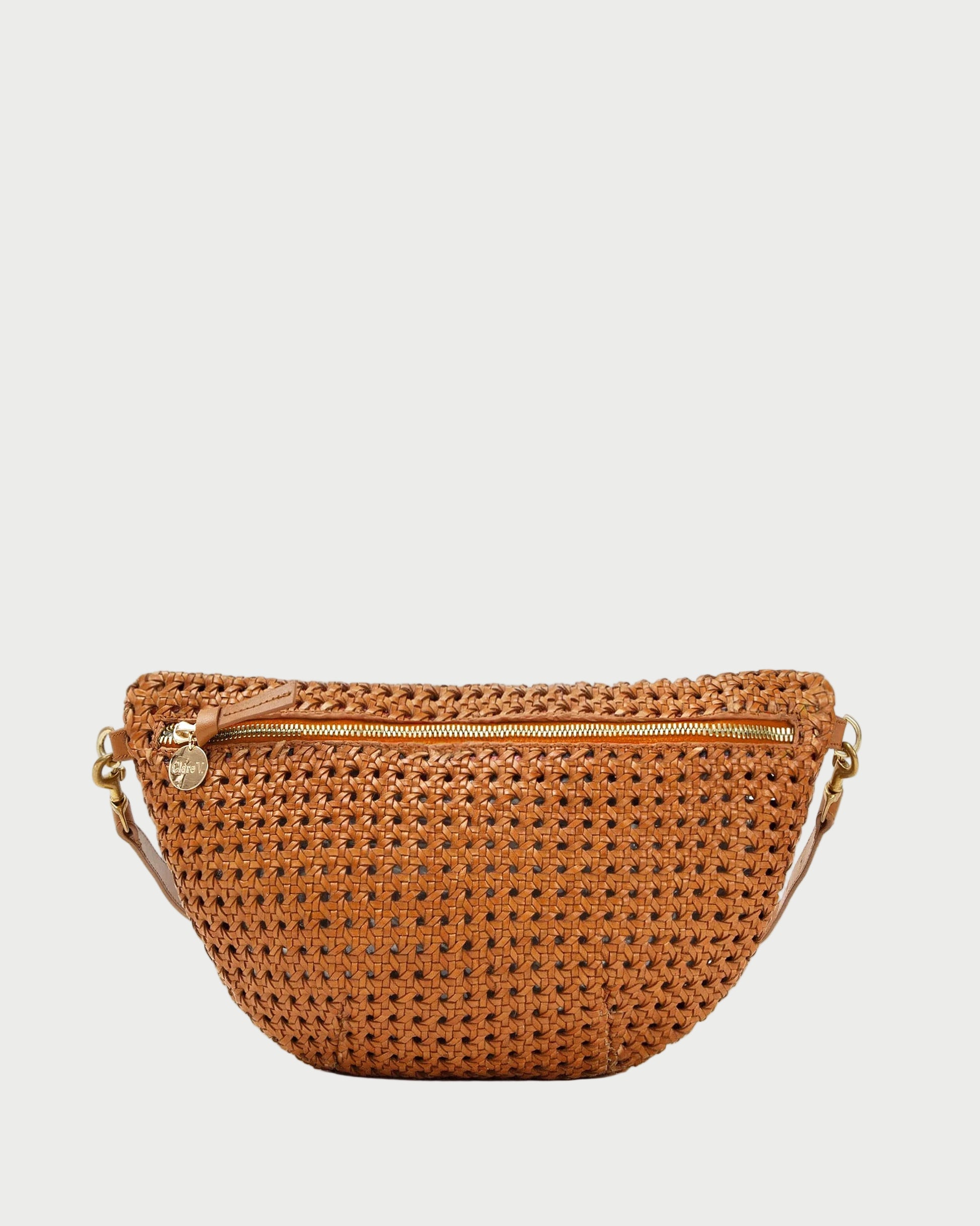 Brown woven belt bag with gold zipper on a white background