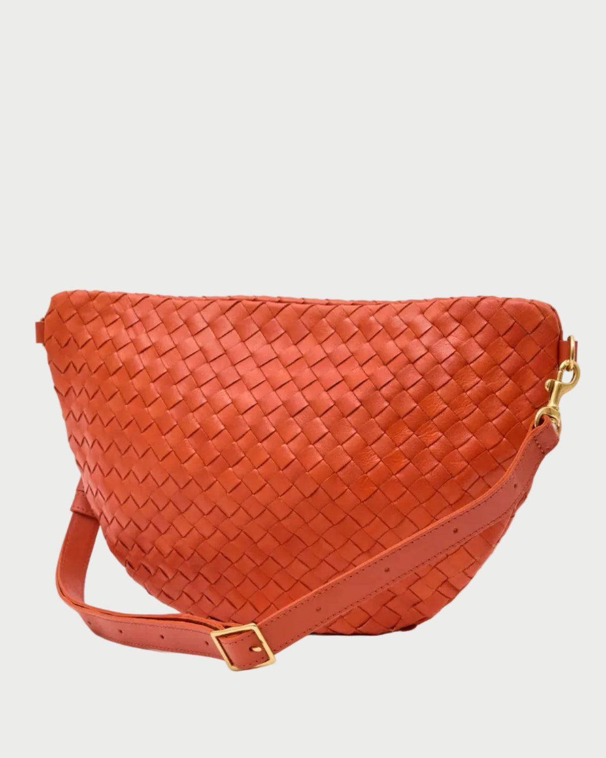 The Clare V. Woven Grande Fanny by CLARE V., an orange woven leather crossbody belt bag with a matching adjustable strap and gold buckle, is shown against a white background.