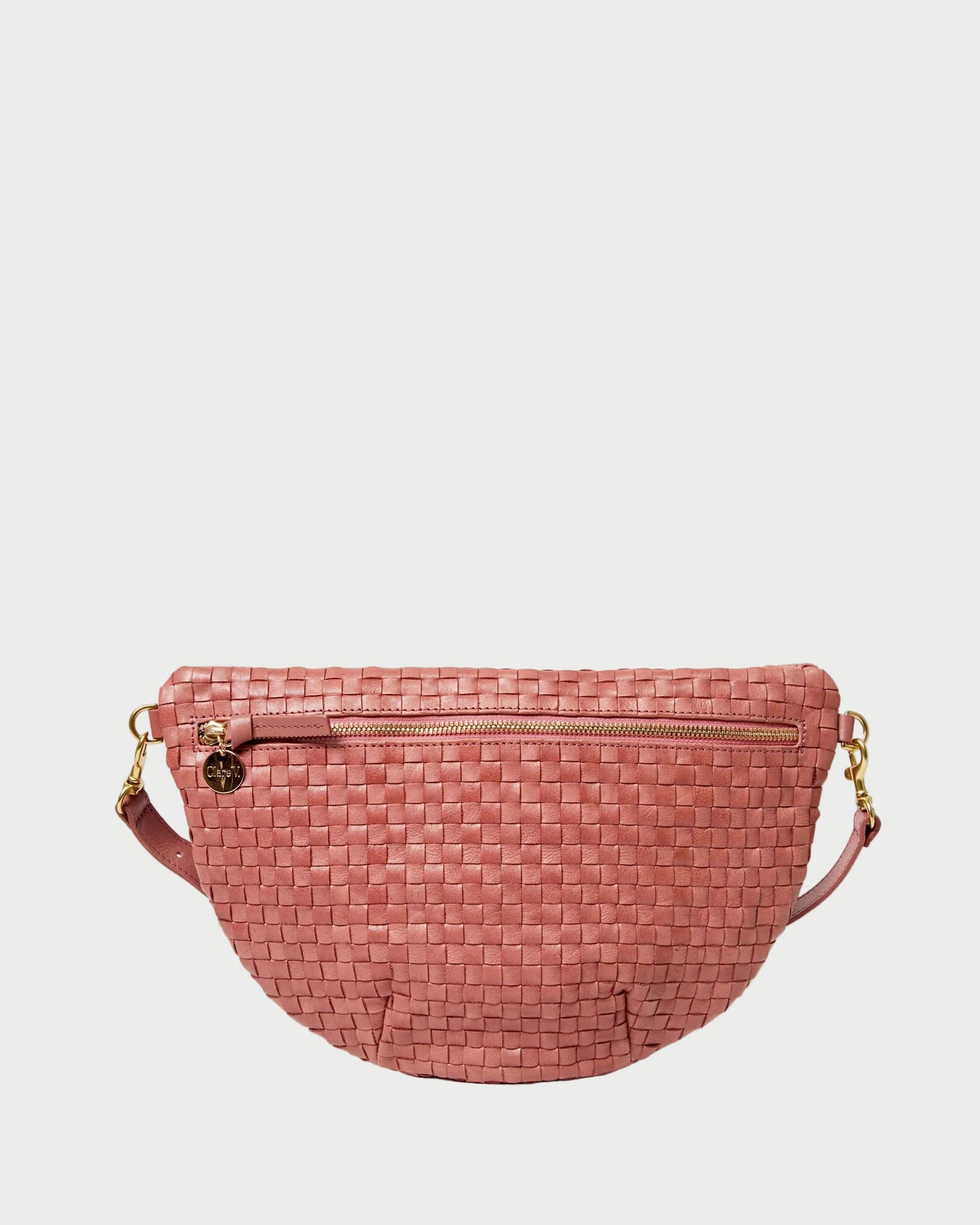 Pink woven handbag on a white background