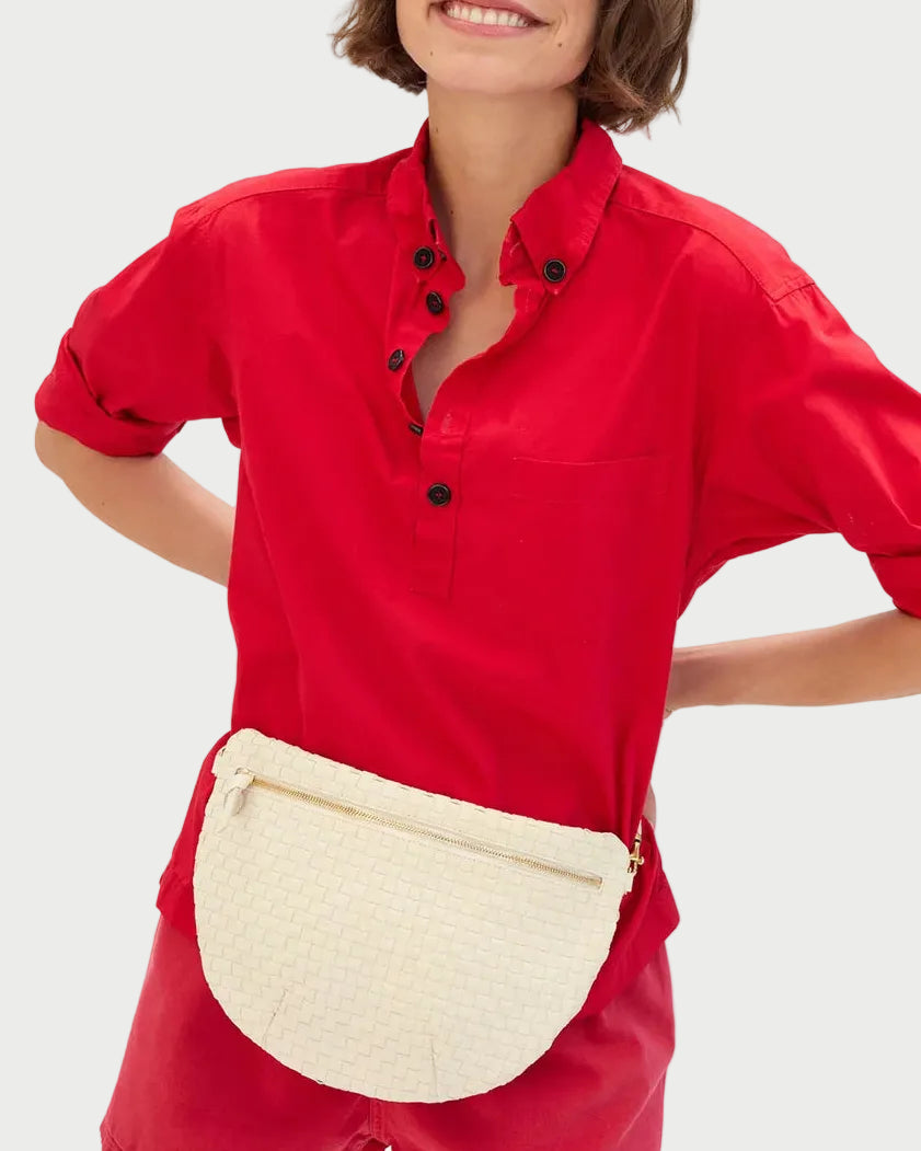 Person wearing a red outfit with a white waist bag on a white background