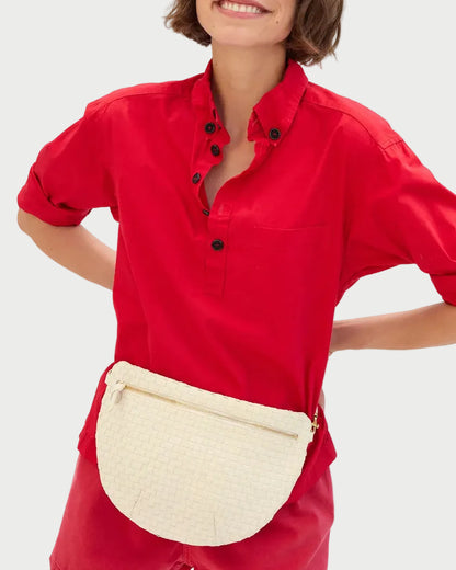 Person wearing a red outfit with a white waist bag on a white background