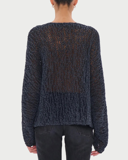 Person wearing a dark blue knitted sweater on a white background