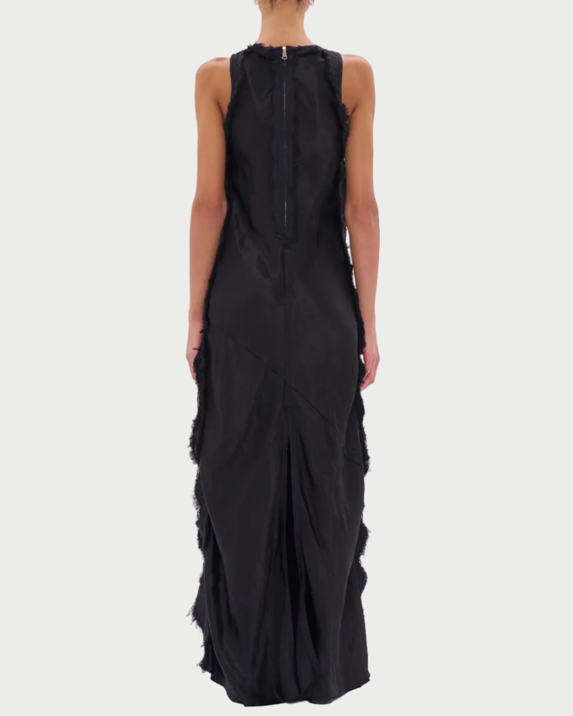 Black sleeveless dress with ruffled details on a white background