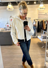 Load image into Gallery viewer, WEST Boutique owner Kitt Shapiro wearing Rains short waterproof jacket and r13 jeans at west2westport.com