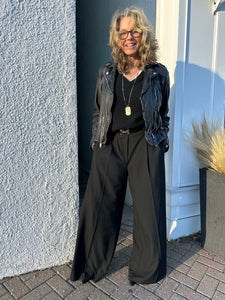 WEST boutique owner Kitt Shapiro wears Saint Art wide leg trousers with black leather Mauritius jacket and zadig & voltaire lightweight cashmere sweater at west2westport.com