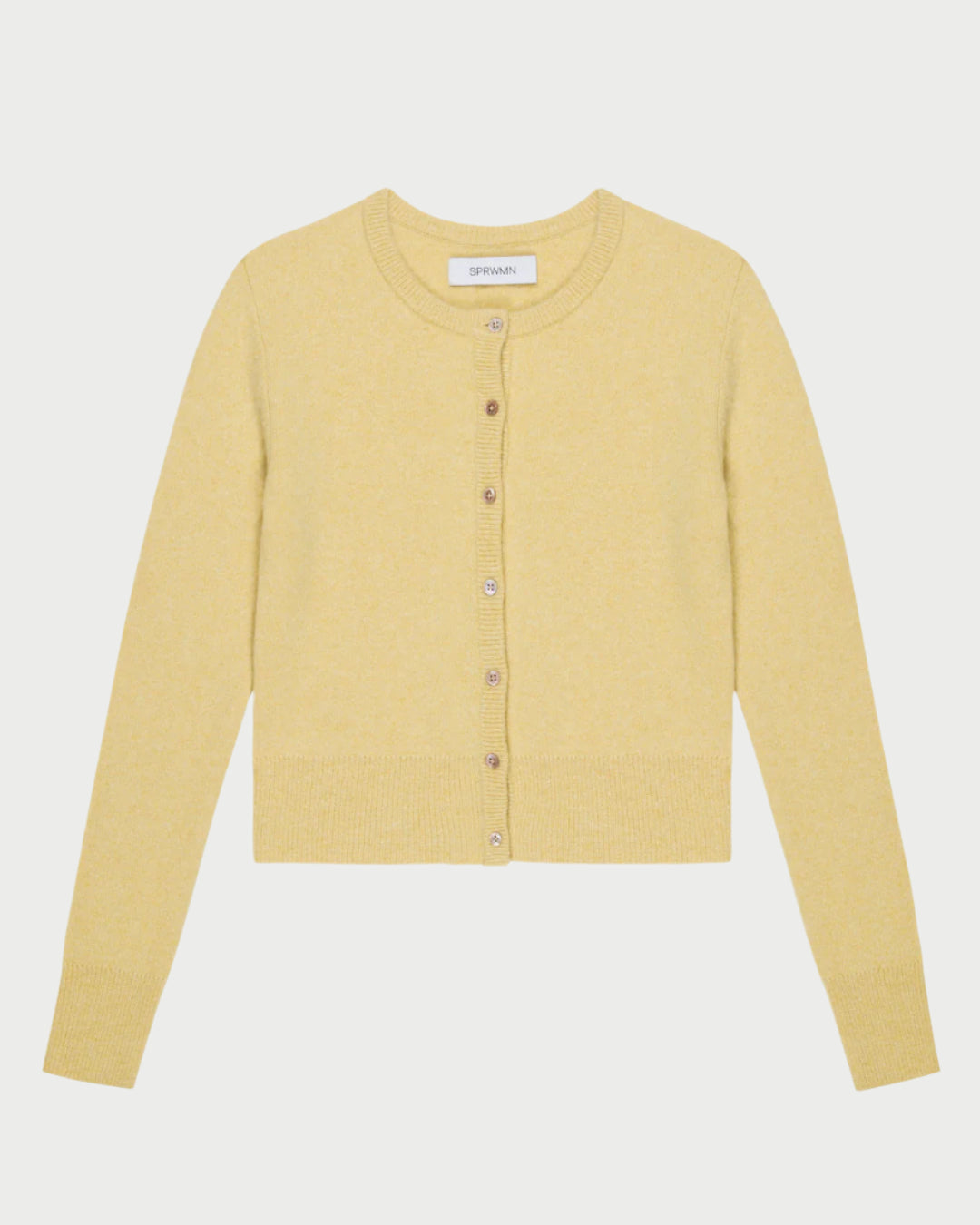 The SPRWMN Baby Cashmere Cardigan is a yellow knit with long sleeves and a round neckline, featuring a front closure with eight matching buttons. It's crafted from sustainably grown fibers and displayed on a plain white background.