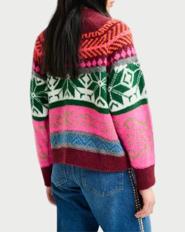 Person wearing a colorful patterned sweater on a plain background