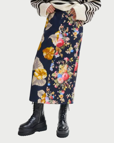 Person wearing a floral skirt with a white background