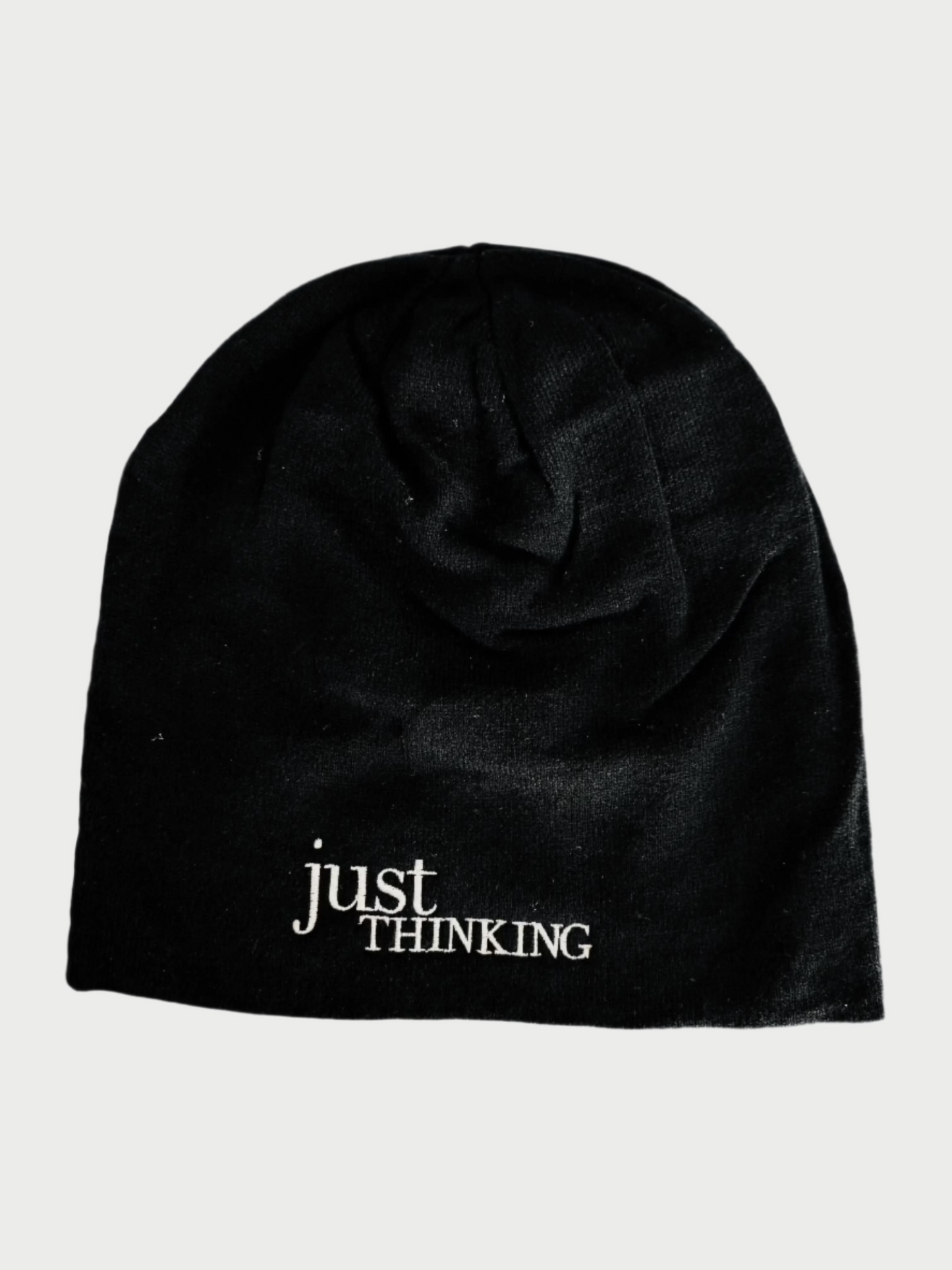 The Slouchy "Just Thinking" Beanie by Simply Eartha is a cozy black winter hat with "just THINKING" embroidered in white on the front, ideal for a thoughtful cap.