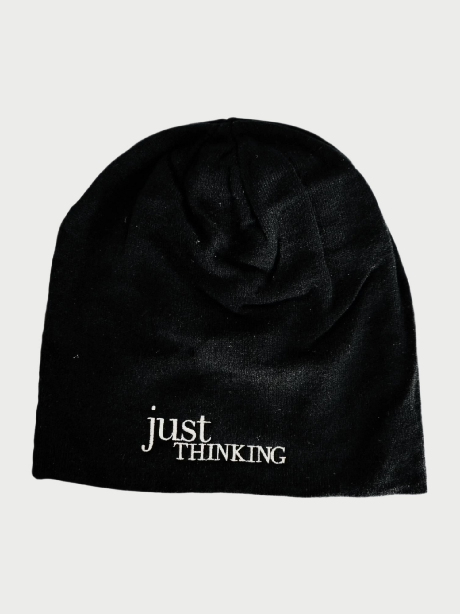 The Slouchy "Just Thinking" Beanie by Simply Eartha is a cozy black winter hat with "just THINKING" embroidered in white on the front, ideal for a thoughtful cap.