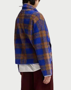 A person is shown from the back against a plain light background, wearing the Essentiel Antwerp Karreau Check Cardigan Jacket in blue and brown plaid over a white shirt and maroon pants.