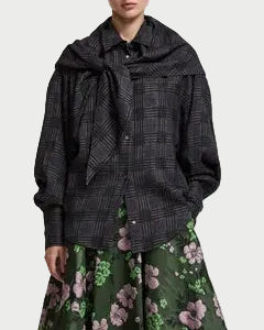 Person wearing the Essentiel Antwerp Kiss Oversized Shirt with matching scarf from Essentiel Antwerp, paired with a green skirt featuring a pink and white floral pattern.