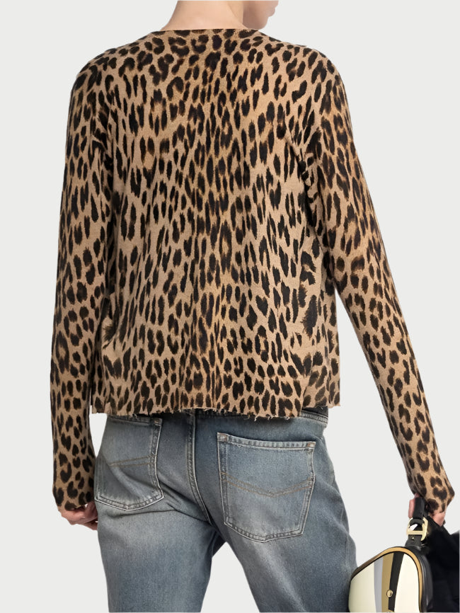 Person wearing a leopard print shirt and blue jeans, holding a helmet on a white background