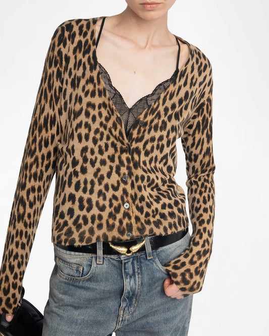 Person wearing a leopard print top and jeans on a white background