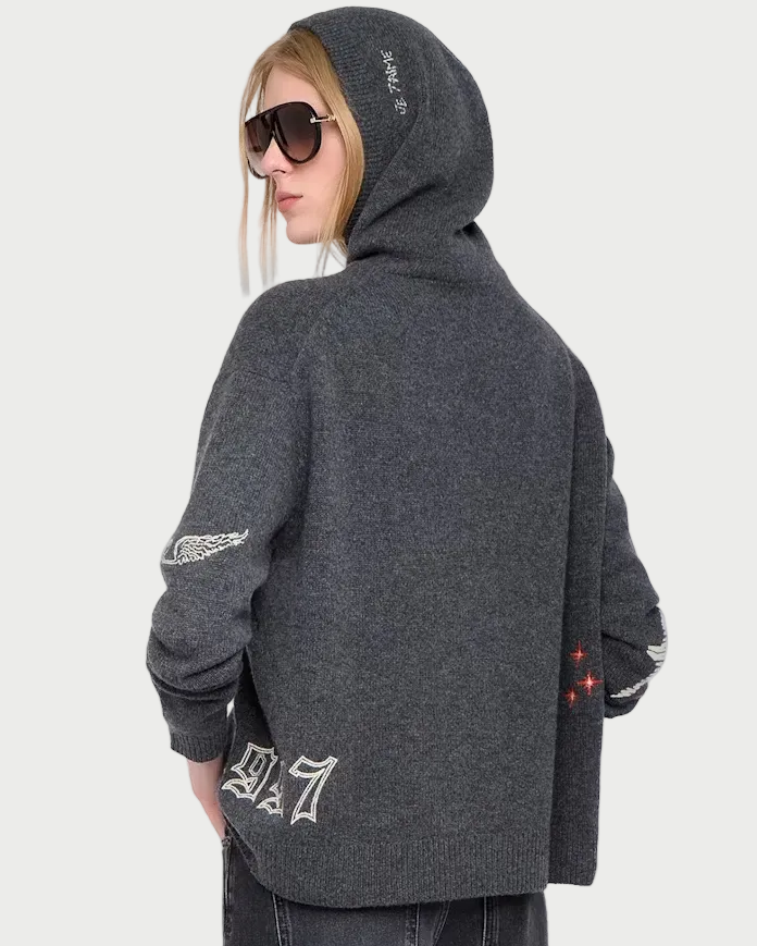 Person wearing a gray hoodie and dark jeans on a white background