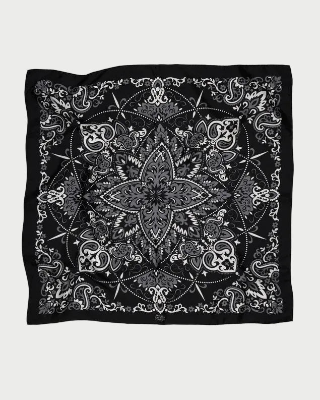 Maison Lecomte Flament Bandana Scarf Black featuring a black silk base with a central grey and white floral mandala pattern surrounded by paisley motifs.