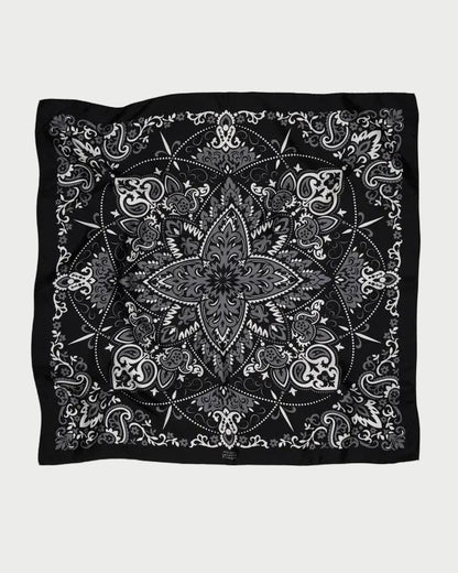Maison Lecomte Flament Bandana Scarf Black featuring a black silk base with a central grey and white floral mandala pattern surrounded by paisley motifs.