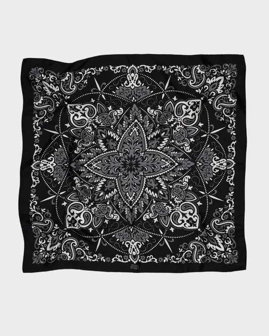 Maison Lecomte Flament Bandana Scarf Black featuring a black silk base with a central grey and white floral mandala pattern surrounded by paisley motifs.