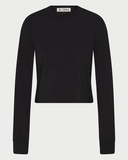 The Éterne Long Sleeve Boxy Tee by Eterne—a plain black, long-sleeve, crew neck sweater made from a cotton-modal blend—is displayed against a white background, with a small label visible at the neckline.