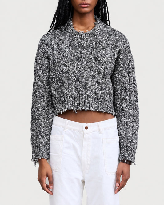 Denimist Leighton Cable Crew sweater in a black and white cable knit with a cropped fit and a distressed, frayed hem.