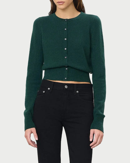 A person wearing the Éterne Reese Cashmere Sweater by Eterne, styled with high-waisted black jeans, stands against a plain white background.