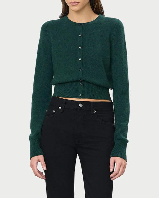 A person wearing the Éterne Reese Cashmere Sweater by Eterne, styled with high-waisted black jeans, stands against a plain white background.