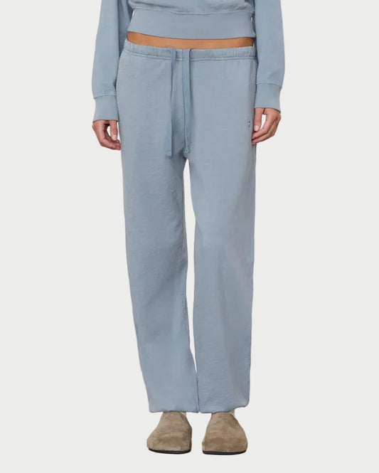 Person wearing a light blue outfit with a matching top and pants on a white background