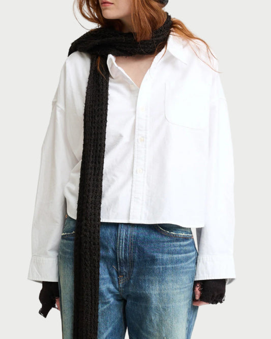 A person wears the Denimist Cropped Button Front Shirt with blue jeans, a long black scarf, and black fingerless gloves. Their long reddish hair is visible, and their face is partially out of frame.