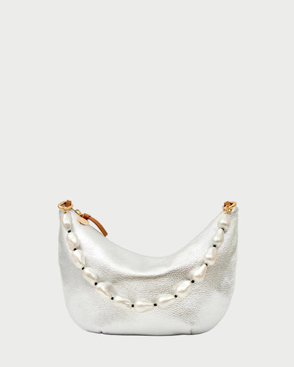 A small, metallic silver handbag with a brown zipper pull, adorned with the CLARE V. Shortie Strap In Pearl—large, irregular pearls draped elegantly across the front.