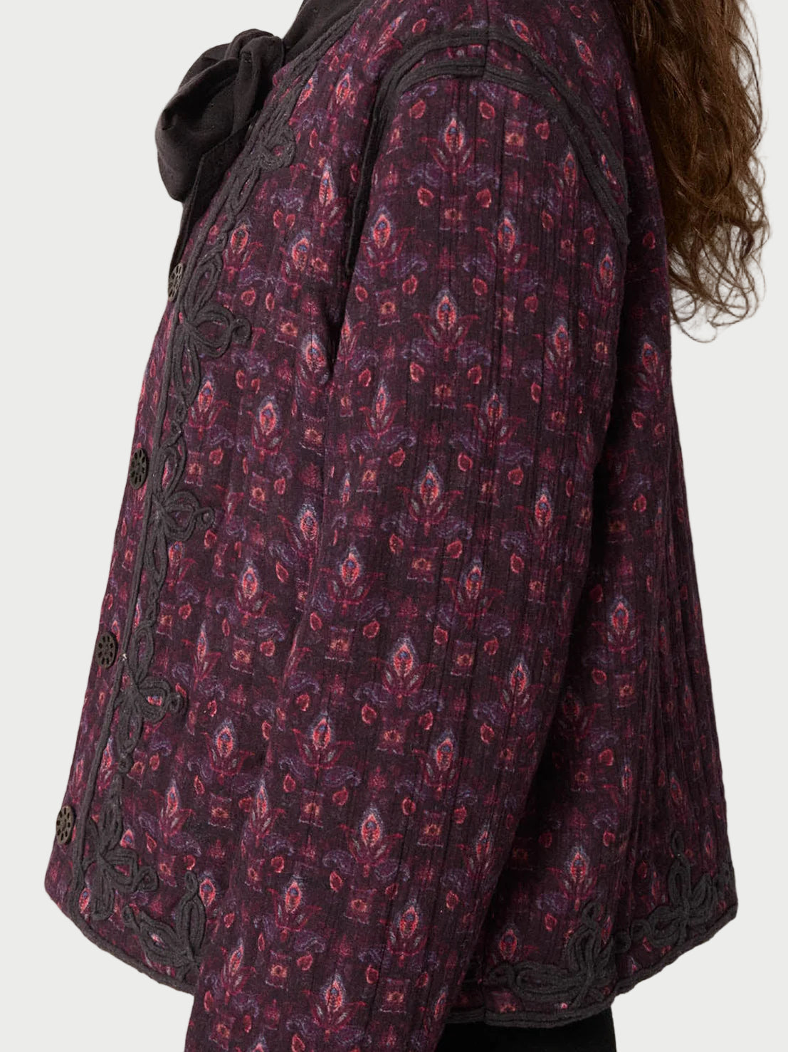 Purple patterned coat with a neutral background