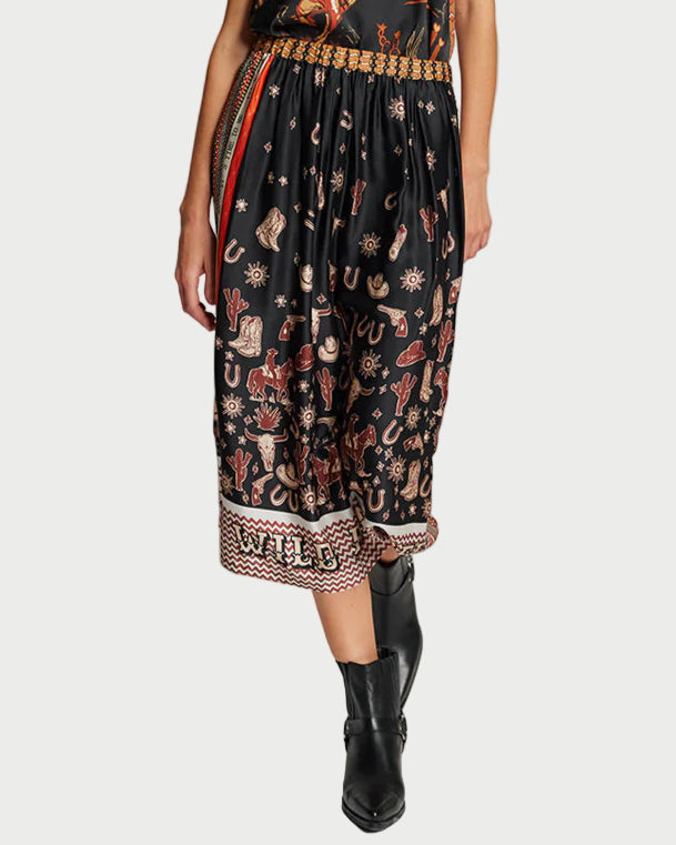 Woman wearing a black floral dress with a belt on a plain background