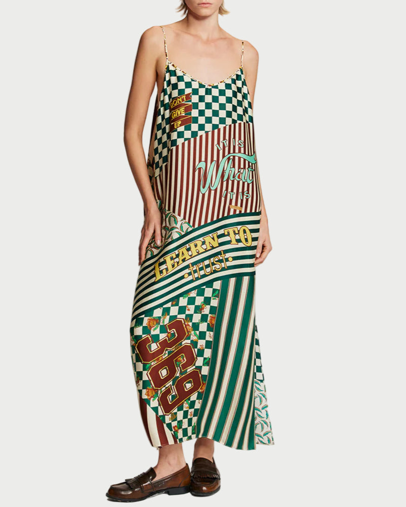 Woman wearing a colorful patterned dress on a plain background